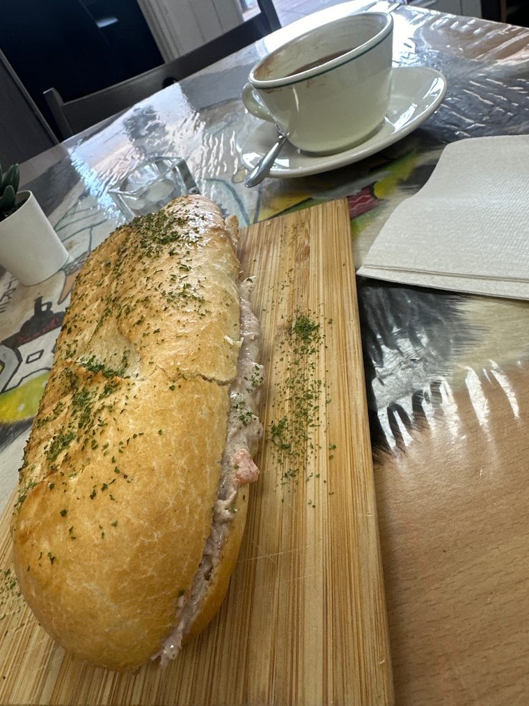 A large filled baguette on a wooden board