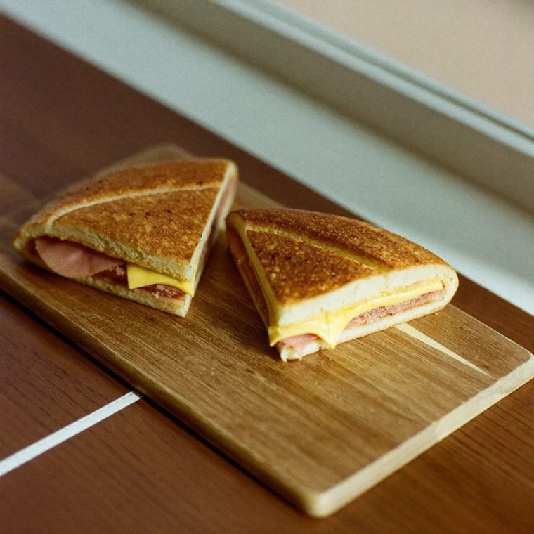 A toasted cheese and ham panini cut on the diagonal